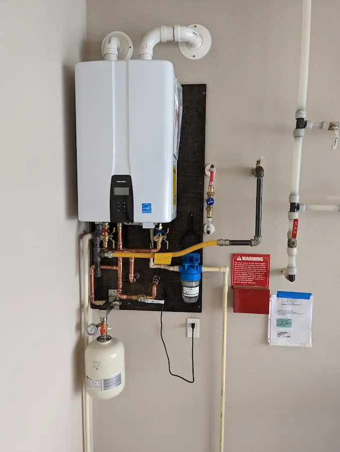 Professional plumber installing copper piping in a L'Anse home